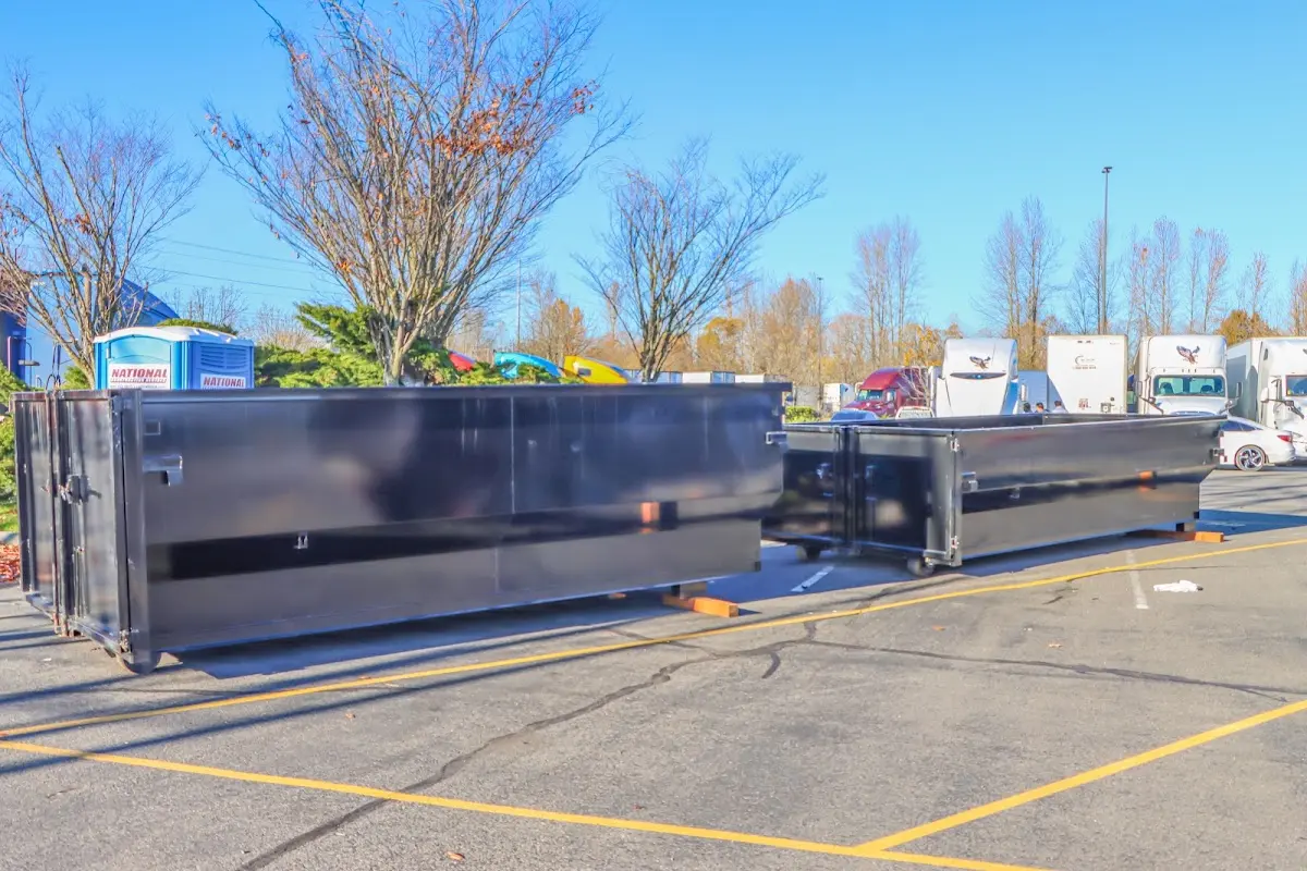 Professional dumpster rental service with roll-off container on residential driveway in Green River